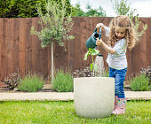 Little girl with a watering can