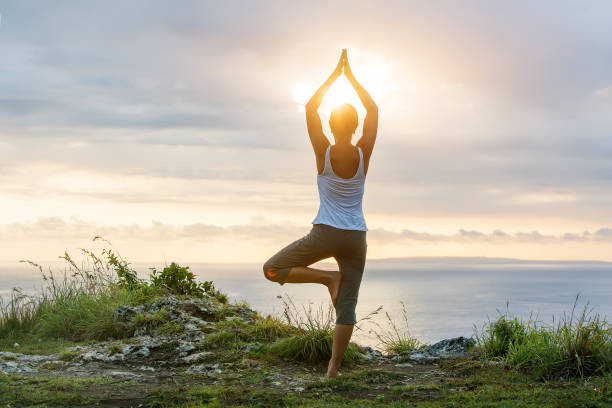 istock Caucasian woman practicing yoga at seashore 1156523770