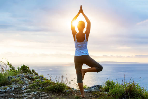 istock Caucasian woman practicing yoga at seashore 1156523772