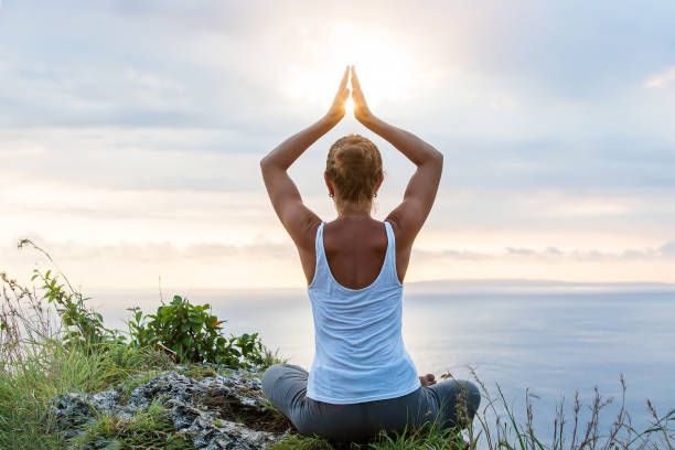 istock Caucasian woman practicing yoga at seashore 1156523773