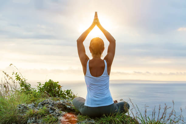 istock Caucasian woman practicing yoga at seashore 1156523774