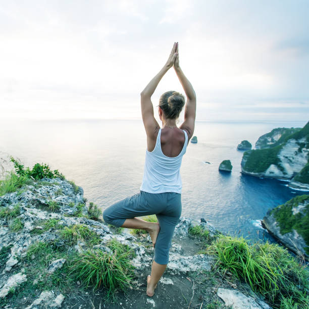 istock Caucasian woman practicing yoga at seashore 1156523789