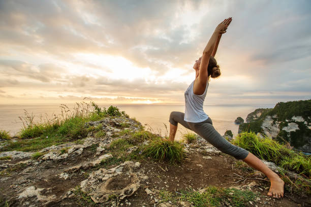 istock Caucasian woman practicing yoga at seashore 1156523800