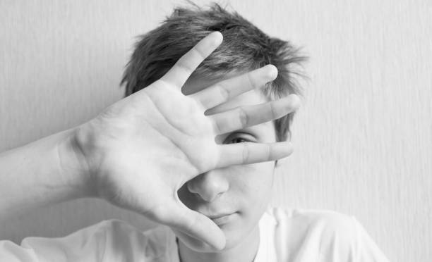 istock Teenager covers his face with his hand 1156523801