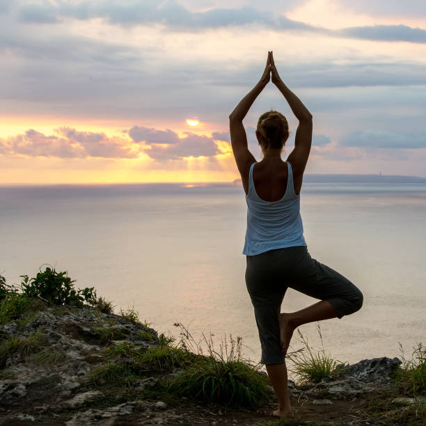 istock Caucasian woman practicing yoga at seashore 1156523815
