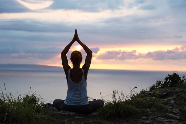 istock Caucasian woman practicing yoga at seashore 1156523834