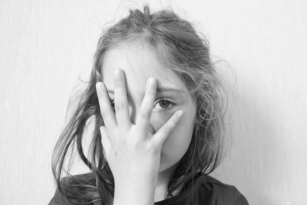 istock Little girl covers her face with her palms 1156523906