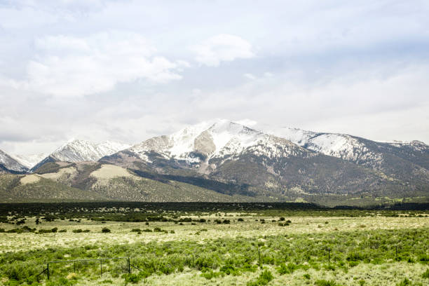 istock Meadow and snow mountain top 1156523908
