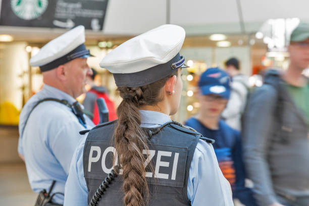 Police in Tegel airport. Berlin, Germany. BERLIN, GERMANY - APRIL 20, 2019: Police patrol in Tegel airport. Police on high terror alert warned to be hyper vigilant. Berlin is the capital and largest city of Germany by both area and population female police officer stock pictures, royalty-free photos & images