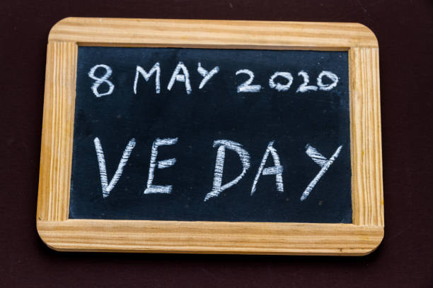 Old fashioned school writing slate with 8 May 2020 VE Day. - fotografia de stock