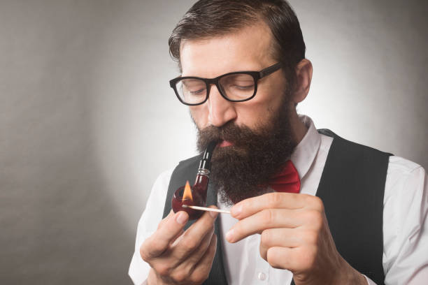 istock bearded man smoking tobacco pipe 1156531293