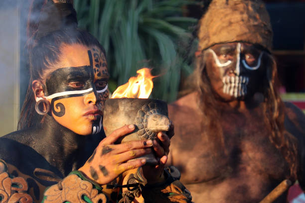 mayan priest and warrior of maya during ancient fire ritual - maquiagem ceremonial imagens e fotografias de stock