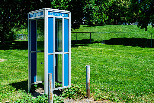 Vintage phone booth in front of a freshly cut lawn