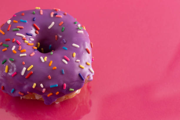 istock A Purple Glazed Donut with Rainbow Sprinkles on Top 1156533895