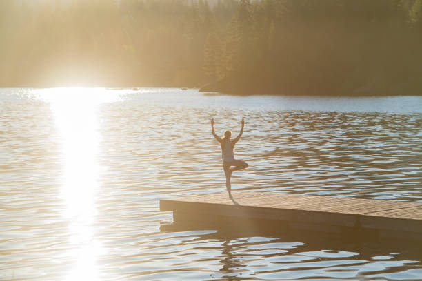 istock Woman doing yoga on dock 1156535000