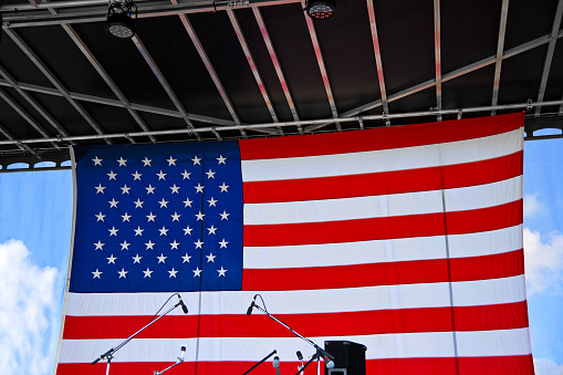 Large American Flag Background on an Outdoor Stage at a July 4th Concert