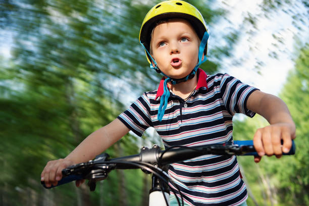 Child cycling in the park portrait close up.