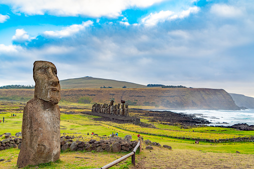 Tourists are watching Moai of Ahu Tongariki, Easter Island, Chile.