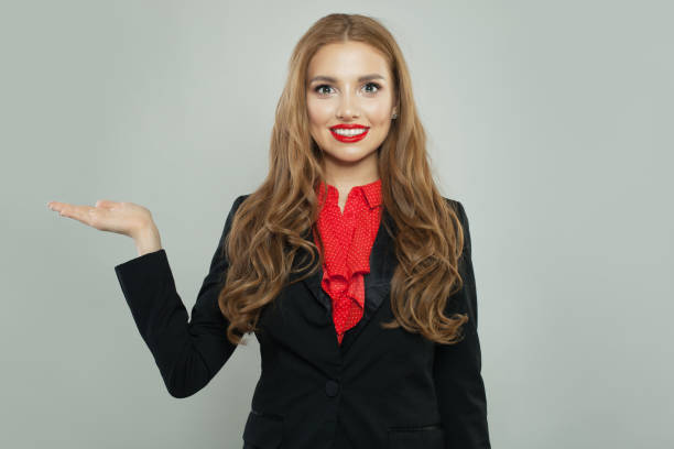 istock Cheerful woman with empty open hand looking at camera and smiling 1156539151