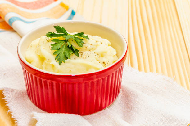 istock Warm mashed potatoes in a ceramic bowl with fresh parsley 1156541548