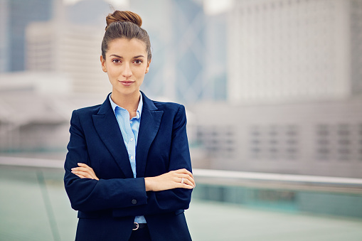 Portrait of young businesswoman at the front of the business district