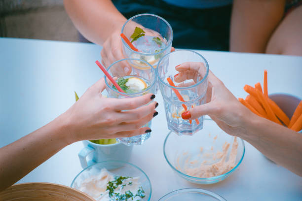 istock Three women cheering with gin tonic 1156544620