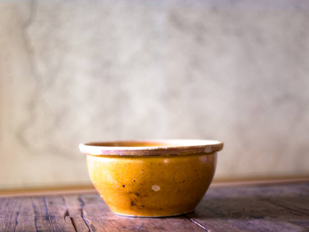 istock Still Life: Antique Yellow Bowl on Old Wood Table 1156547489