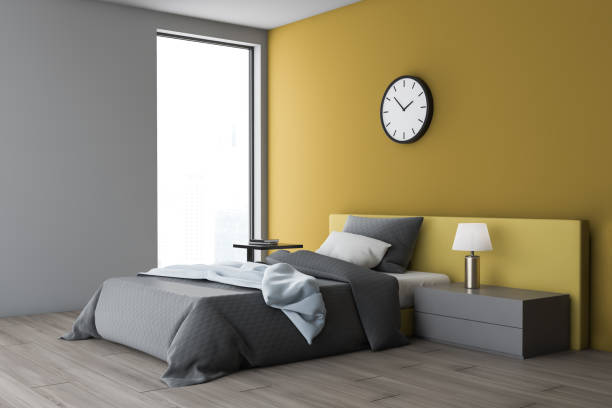 istock White and yellow bedroom corner with clock 1156547594