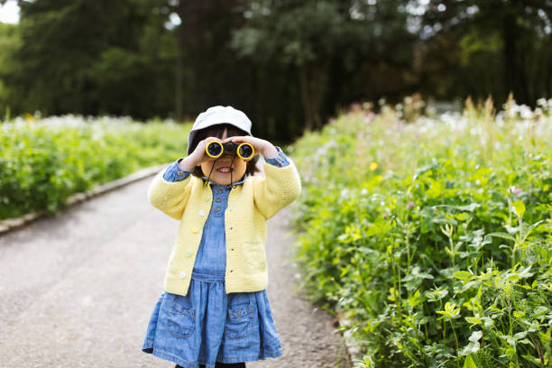 istock toddler girl playing exploration in spring park 1156548905