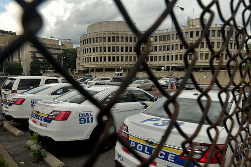 Philadelphia, PA, USA - June 17, 2019; Dark clouds pack the skies over the aging Philadelphia Police department (PPD) headquarters, nicknamed the Roundhouse in Center City Philadelphia, PA on June 17, 2019.
