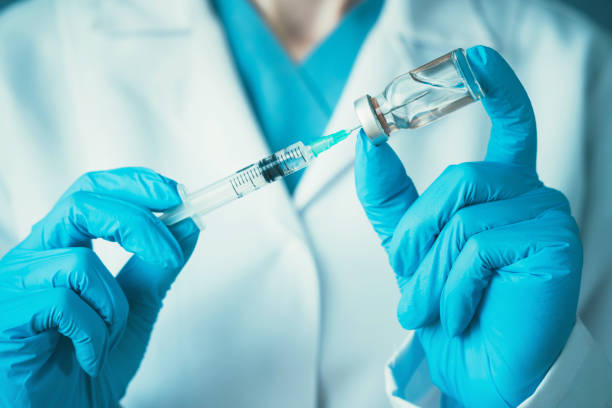 istock The doctor prepares the syringe for vaccination 1156555077