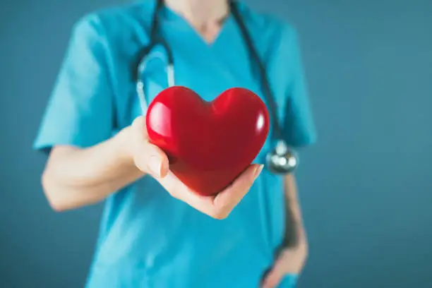 Photo of Medicine doctor holding red heart shape in hand, medical concept