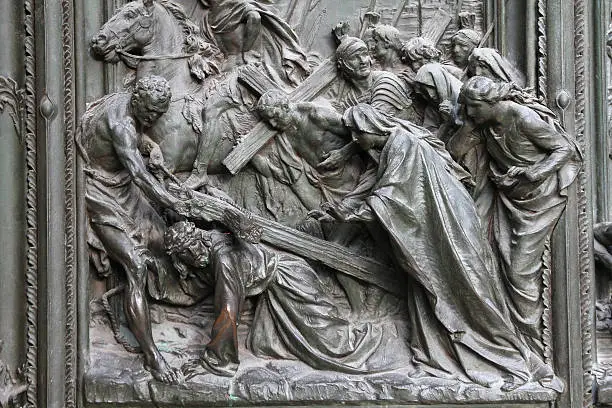 Milan, Italy. Famous landmark - the cathedral door. Jesus Christ, way of the Cross - biblical story.