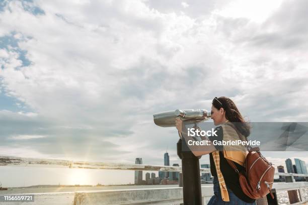 Woman Traveling In New York Using The Tourist Binoculars Stock Photo - Download Image Now