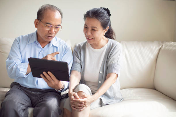 istock Elderly couple watching at tablet screen 1156563597