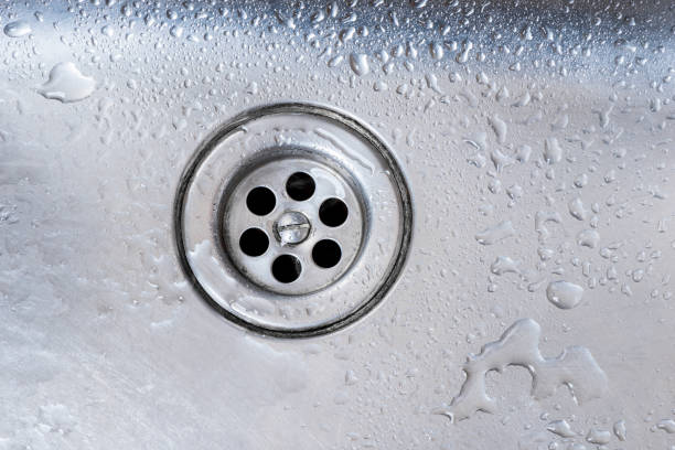 istock drain of stainless kitchen sink close up 1156573612