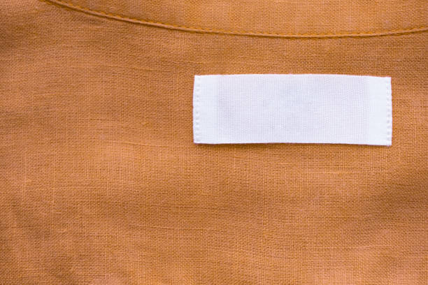 istock White blank clothing tag label on brown linen shirt fabric texture background 1156573907