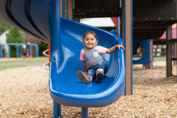 istock A toddler-age girl riding down the slide 1156574258