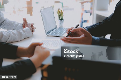 istock lawyer insurance broker consulting giving legal advice to couple customer about buying renting house. financial advisor with mortgage loan investment contract. Real Estate Agent selling real estate 1156574440