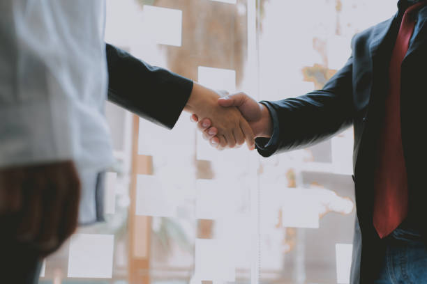 istock Business people shaking hands after meeting. colleagues handshaking. teamwork partnership concept. 1156574449