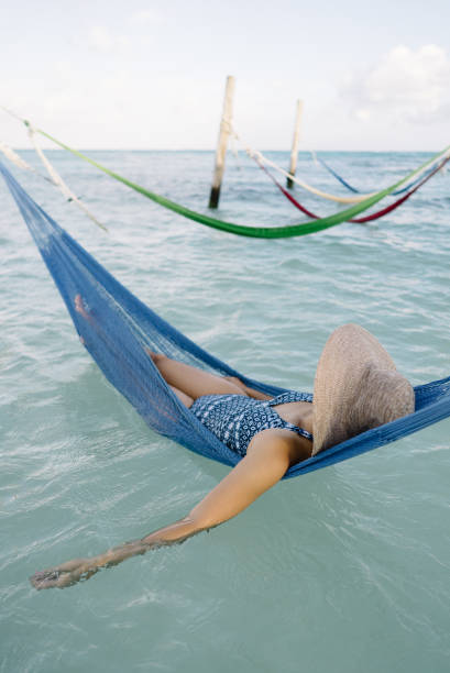 Empty over-water hammock in the middle of tropical lagoon