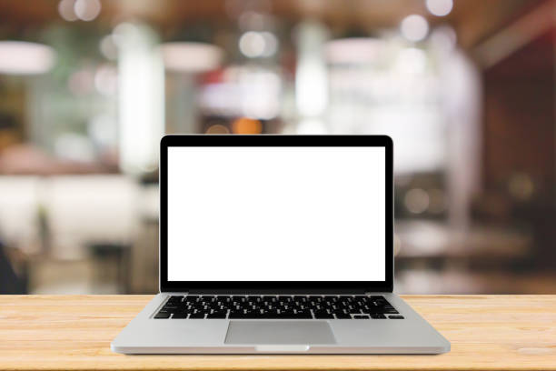istock Blank screen laptop computer on wood table top with blur cafe restaurant with abstract bokeh light defocused background 1156575200