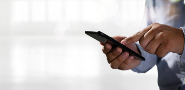 istock man holding en hands and using digital tablet  Mobile Phone telephone with blank copy space scree 1156576924