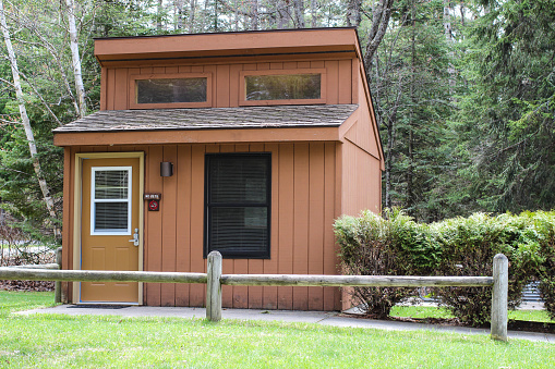 Roscommon, Michigan, USA - May 9, 2015: Exterior of Michigan State Park rental cabin available to state park visitors for overnight accommodations.The state park system has over 60 mini cabins to rent in 36 of it's state parks.