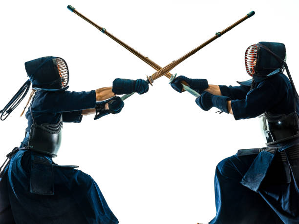 istock Kendo martial arts fighters silhouette isolated white bacground 1156601847