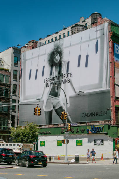 Calvin Klein billboard New York, 6/15/2019: View of a large Calvin Klein billboard set up on a side of a building along Houston Street. soho billboard stock pictures, royalty-free photos & images