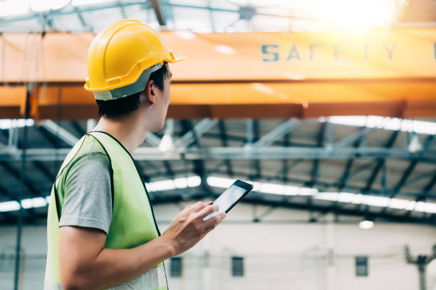 istock Young Asian male factory worker using a digital tablet 1156617940