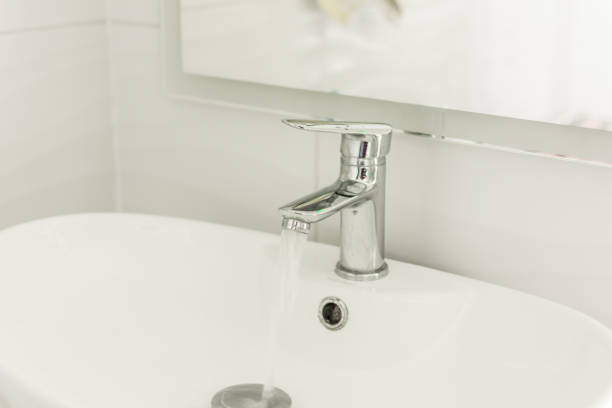 istock Mixer tap with water flowing. 1156618758