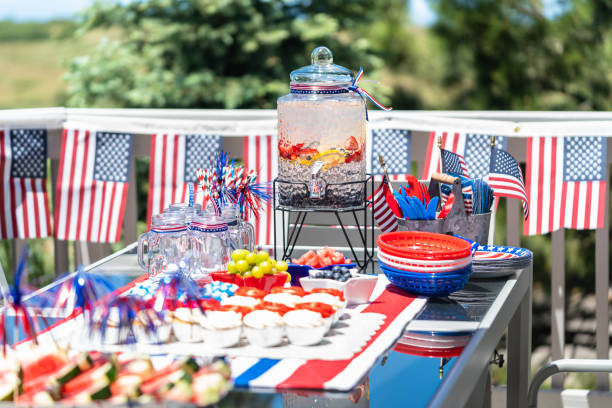 istock Table with food and drinks set for celebrating July 4th on the back patio. 1156619724