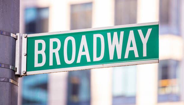 istock Broadway road sign. Blur buildings facade background, Manhattan downtown 1156619727
